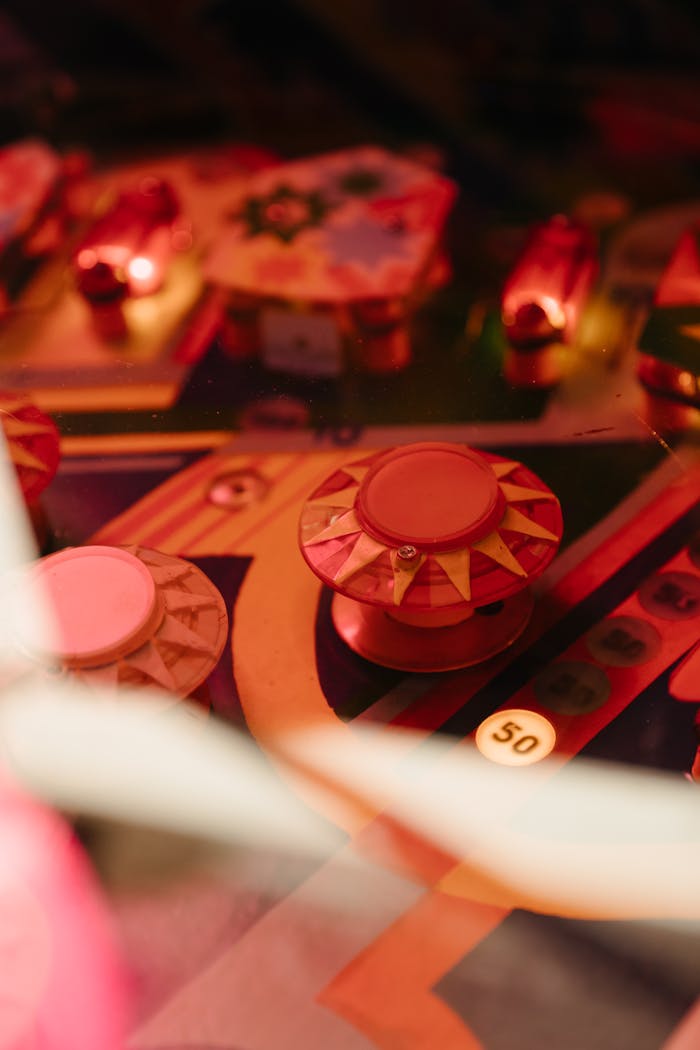 about-us Colorful vintage pinball machine with illuminated bumpers and intricate details.